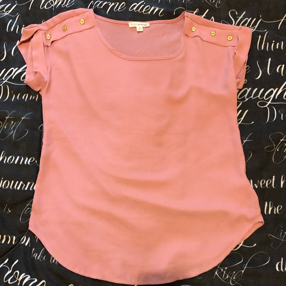 Small pink women’s top with gold accent buttons